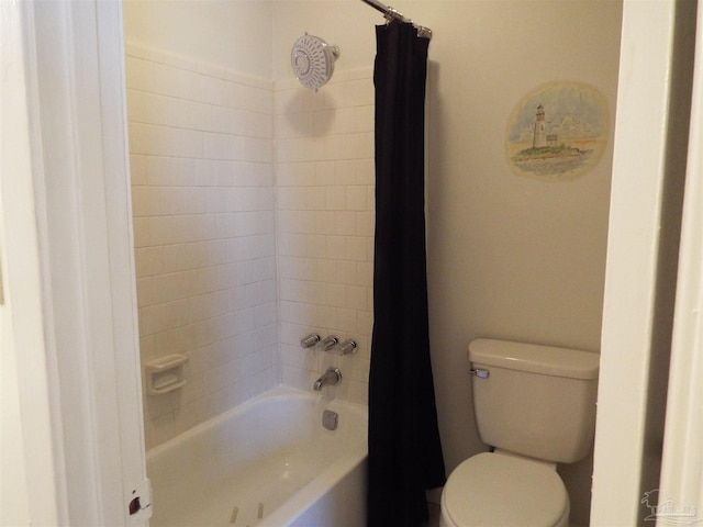 bathroom featuring toilet and shower / bath combination with curtain