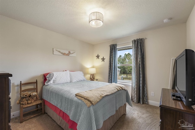 carpeted bedroom featuring a textured ceiling and baseboards