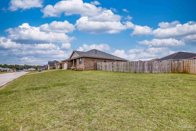 view of yard featuring a garage and fence