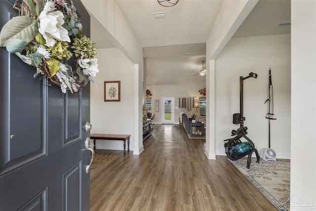 entrance foyer featuring ceiling fan, dark wood-type flooring, visible vents, and baseboards