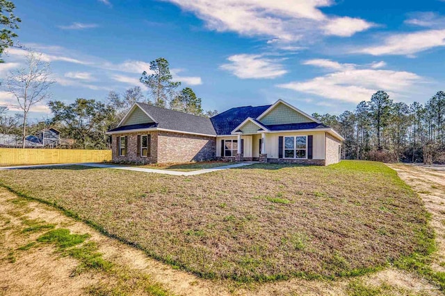 view of front of house with fence and a front lawn