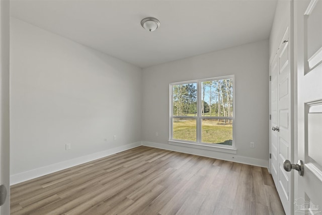 interior space featuring light wood finished floors and baseboards