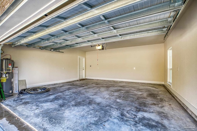 garage featuring a garage door opener, electric water heater, and baseboards