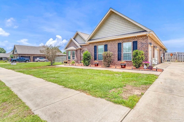 2704 Wildhurst Trl, Pace, FL 32571 - view of front facade with brick siding, concrete driveway, and a garage