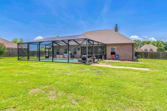 2704 Wildhurst Trl, Pace, FL 32571 - back of house featuring a fenced backyard, a chimney, and glass enclosure