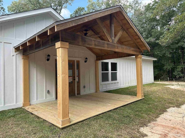 5661 Dupree Rd, Milton, FL 32570 - back of house with board and batten siding, a deck, and a yard