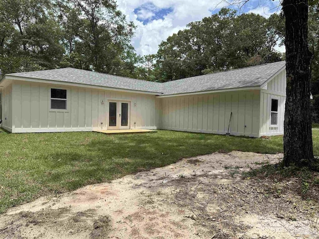5661 Dupree Rd, Milton, FL 32570 - back of property featuring board and batten siding, french doors, a shingled roof, and a lawn