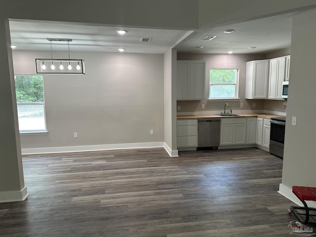 5661 Dupree Rd, Milton, FL 32570 - kitchen with appliances with stainless steel finishes, white cabinets, dark wood-style floors, light countertops, and recessed lighting