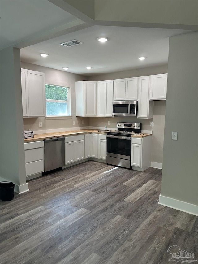 5661 Dupree Rd, Milton, FL 32570 - kitchen with appliances with stainless steel finishes, white cabinets, recessed lighting, dark wood-type flooring, and light countertops