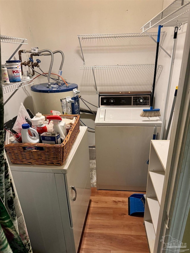 washroom featuring washer and dryer, light wood-type flooring, and electric water heater