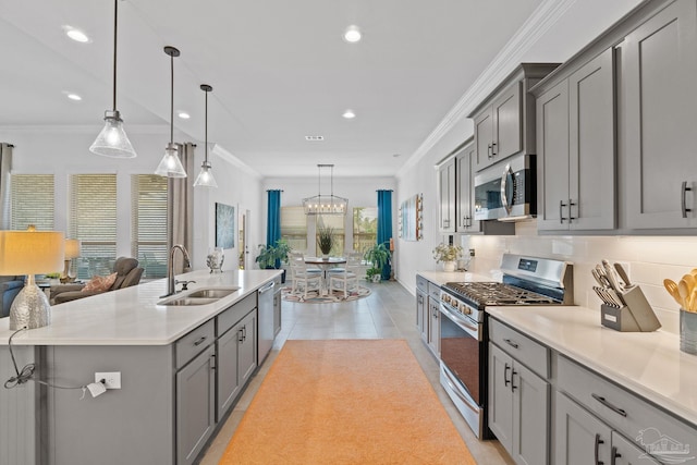 kitchen with recessed lighting, a sink, appliances with stainless steel finishes, and gray cabinets