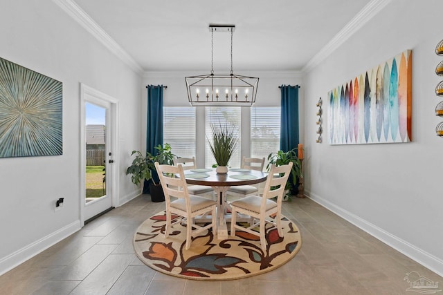 dining room with baseboards, a notable chandelier, and crown molding
