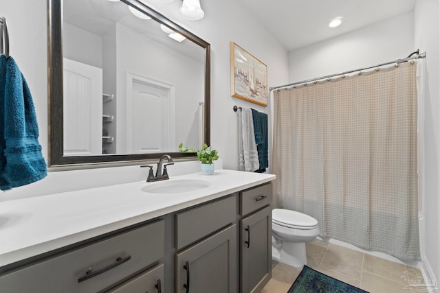 full bath featuring toilet, tile patterned floors, shower / tub combo, and vanity