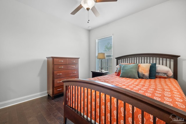 bedroom with dark wood-style flooring, ceiling fan, and baseboards
