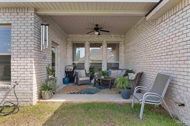 exterior space with outdoor lounge area, brick siding, a patio, and a ceiling fan