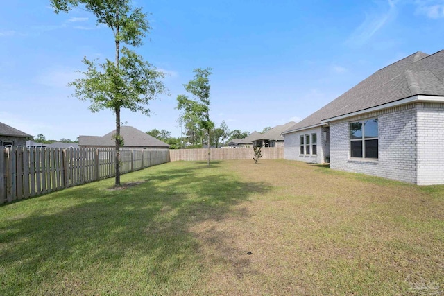 view of yard with a fenced backyard