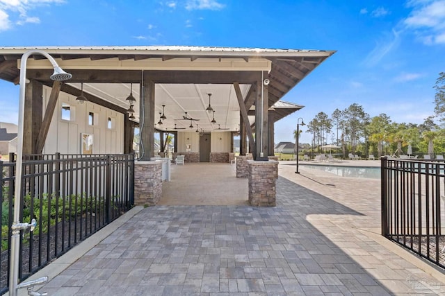 view of patio / terrace featuring a community pool and fence