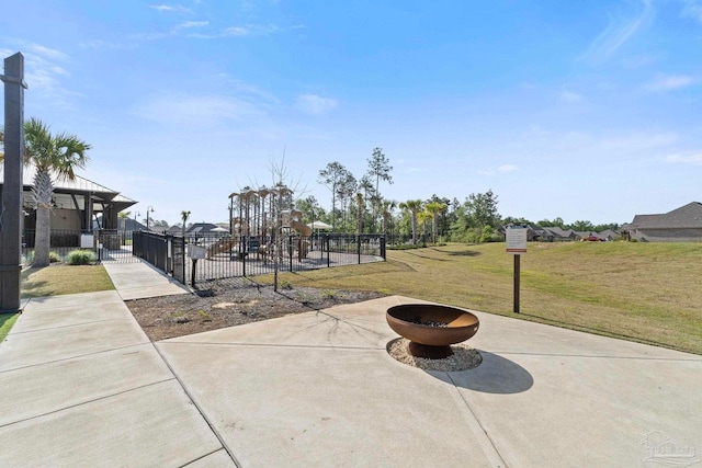 view of community with fence and a lawn