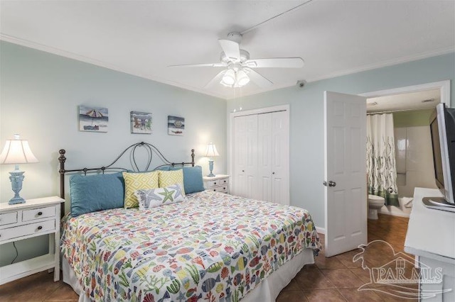 bedroom featuring ceiling fan, a closet, ornamental molding, and dark tile patterned flooring