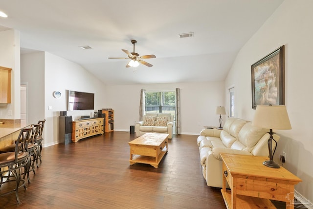 living room featuring ceiling fan, vaulted ceiling, and dark hardwood / wood-style flooring