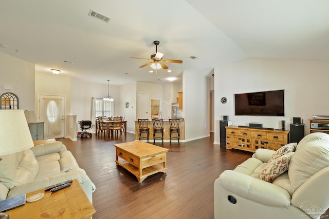 living room with ceiling fan, dark hardwood / wood-style flooring, and lofted ceiling