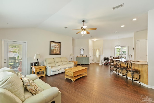 living room with sink, dark hardwood / wood-style flooring, ceiling fan with notable chandelier, and vaulted ceiling