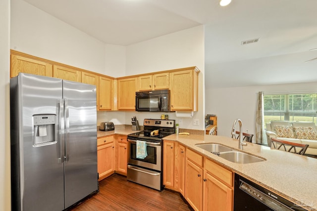 kitchen with light brown cabinetry, dark hardwood / wood-style floors, sink, a high ceiling, and black appliances