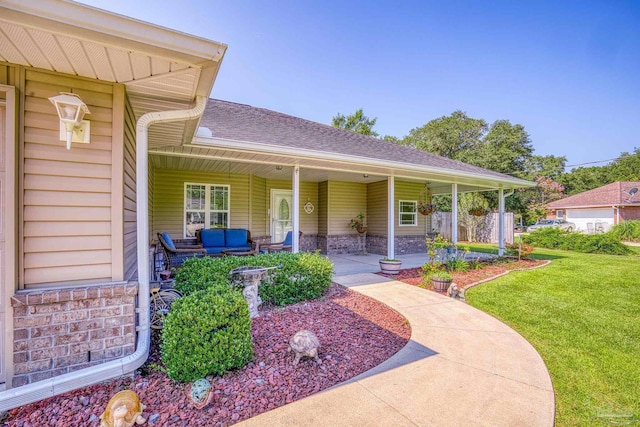 doorway to property with a lawn and covered porch