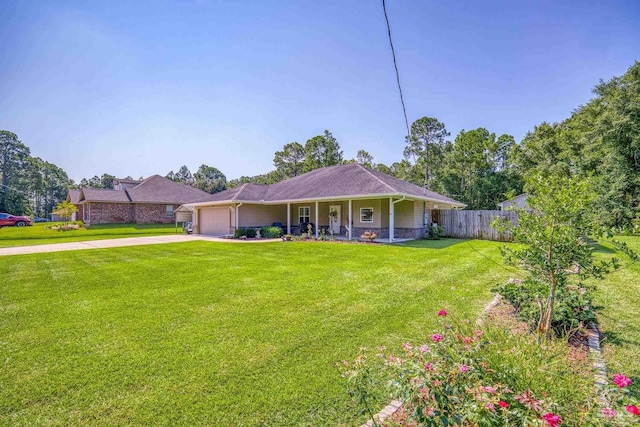 view of front of home featuring covered porch, a front yard, and a garage