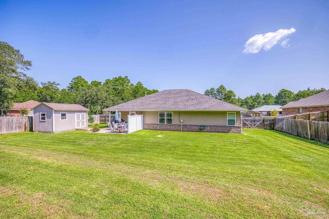 rear view of property featuring an outdoor structure and a lawn