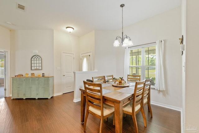 dining area featuring dark hardwood / wood-style flooring and a chandelier