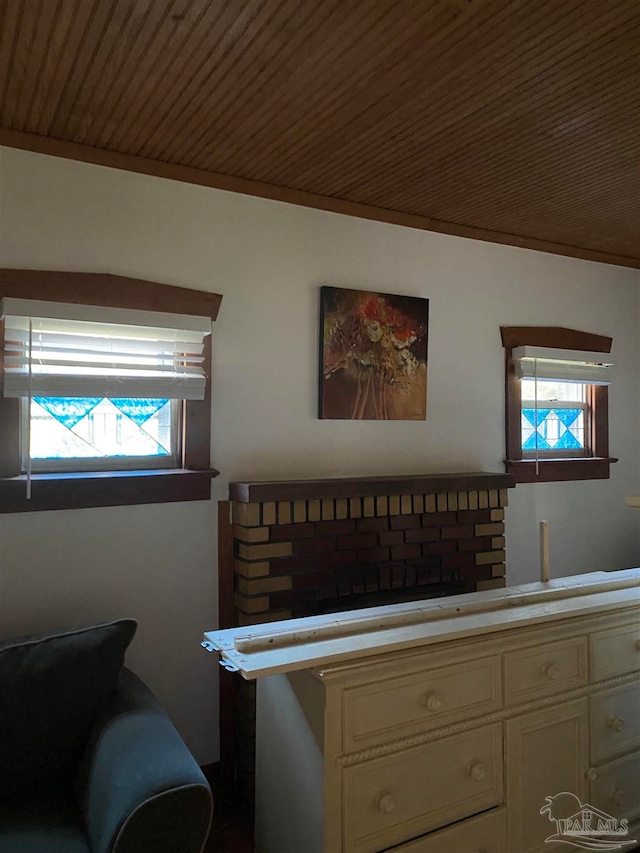 interior space with wood ceiling and ornamental molding