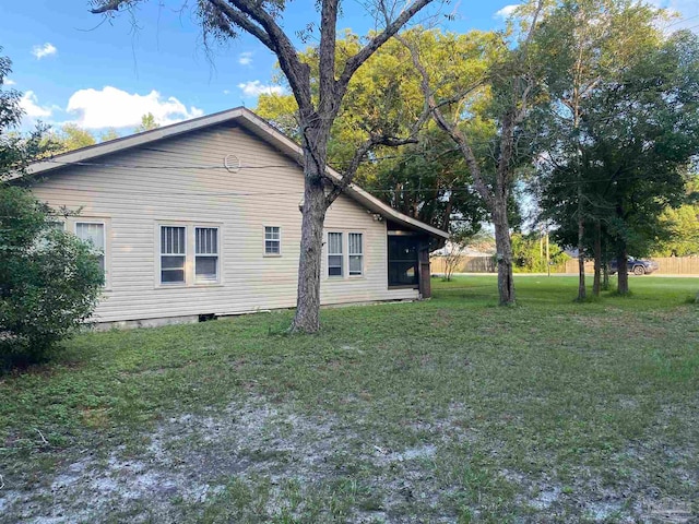 view of side of home featuring a yard