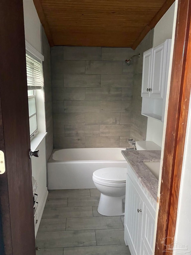 full bathroom featuring wood ceiling, wood-type flooring, tiled shower / bath combo, vanity, and toilet