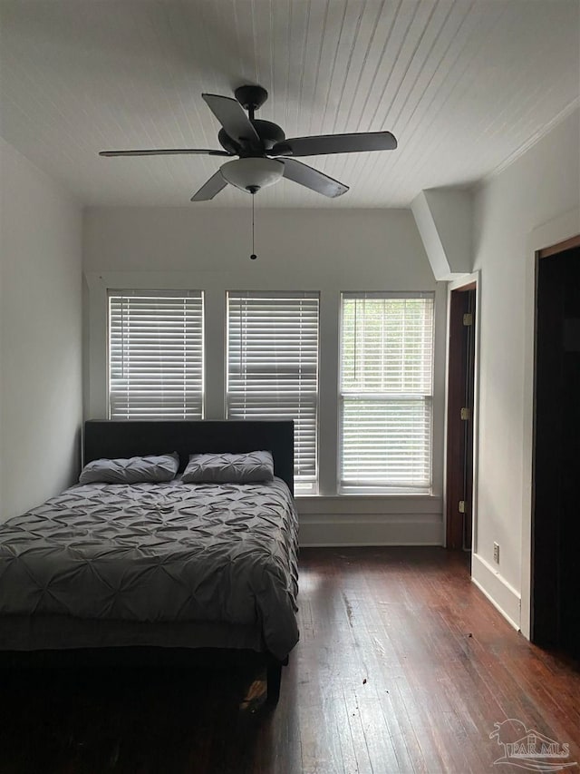 unfurnished bedroom featuring dark wood-type flooring and ceiling fan