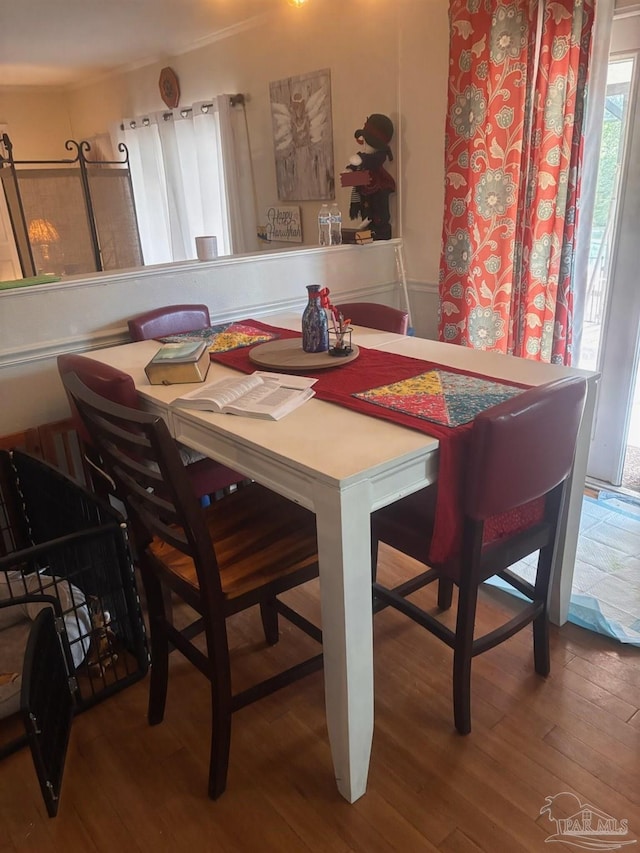 dining space with hardwood / wood-style flooring