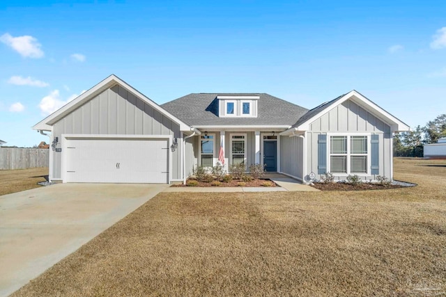 craftsman house with a garage and a front lawn