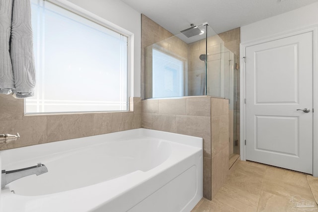 bathroom with a healthy amount of sunlight, tile patterned floors, and shower with separate bathtub