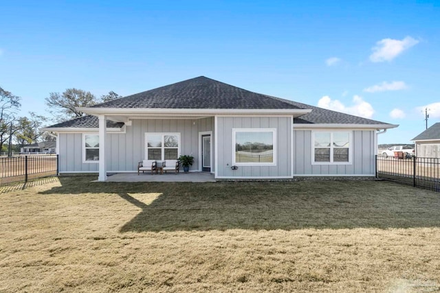 back of property featuring a yard and a patio