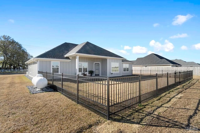 rear view of property with a yard