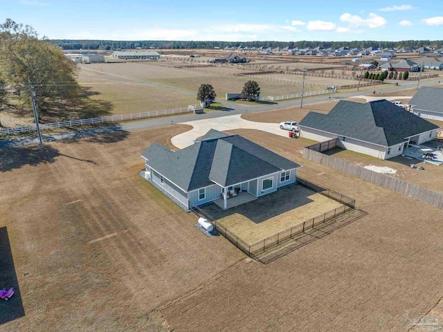 birds eye view of property with a rural view