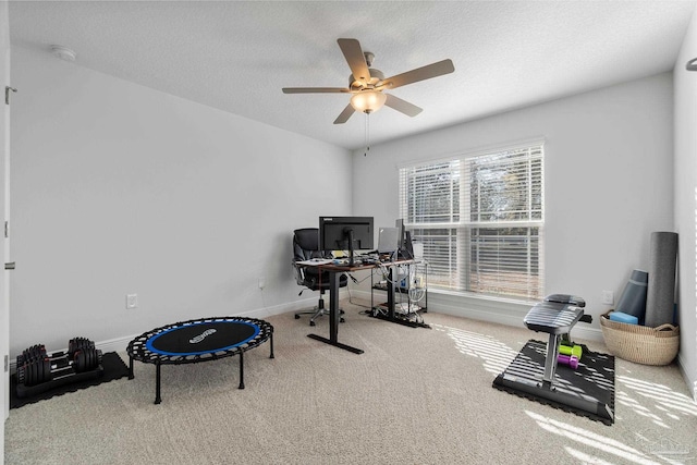 office area with ceiling fan, carpet, and a textured ceiling