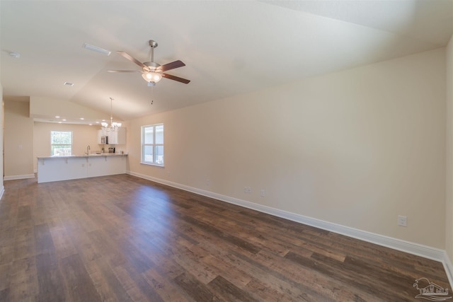 unfurnished living room featuring lofted ceiling, sink, ceiling fan with notable chandelier, and dark hardwood / wood-style floors