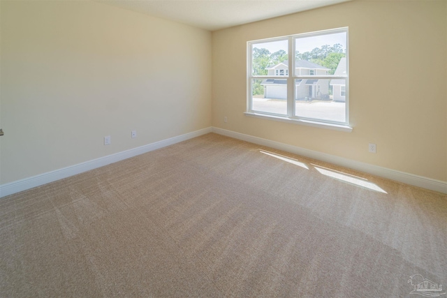 unfurnished room featuring light carpet