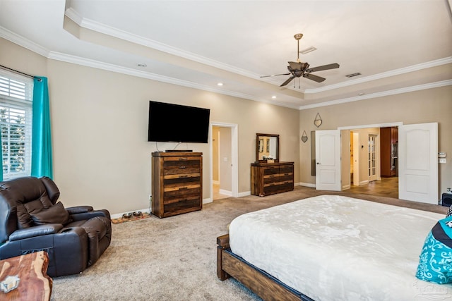 carpeted bedroom with a raised ceiling, ceiling fan, and ornamental molding