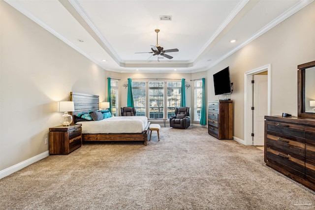 bedroom featuring a raised ceiling, ceiling fan, crown molding, and light carpet