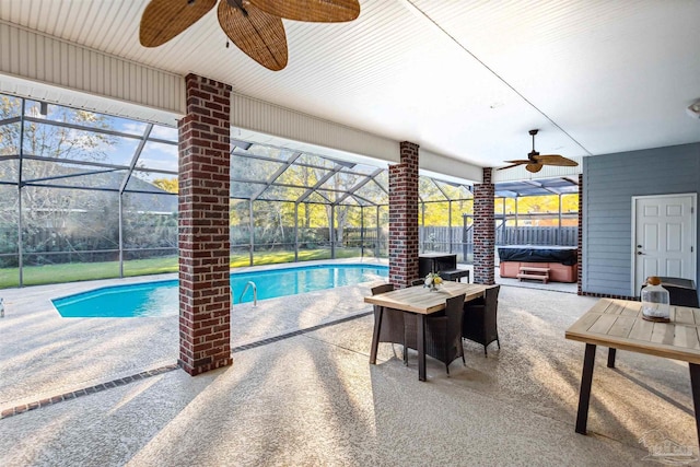 view of swimming pool featuring a patio, a hot tub, and a lanai