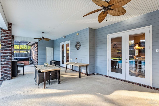 view of patio / terrace with a jacuzzi, french doors, and ceiling fan