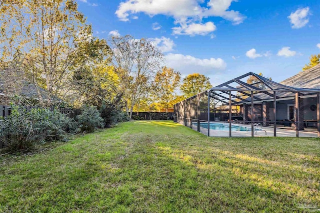 view of yard with a lanai and a fenced in pool