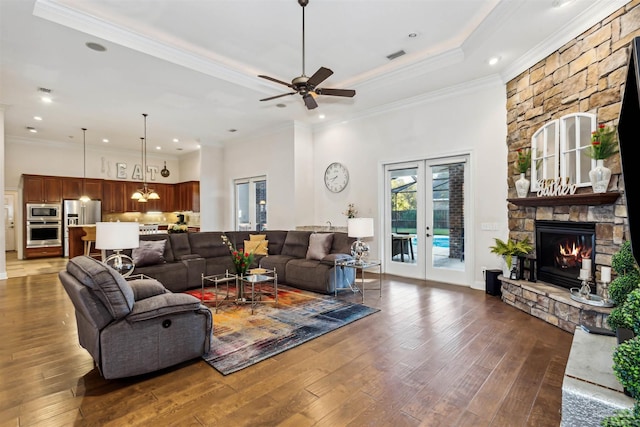 living room featuring french doors, crown molding, ceiling fan, and dark wood-type flooring